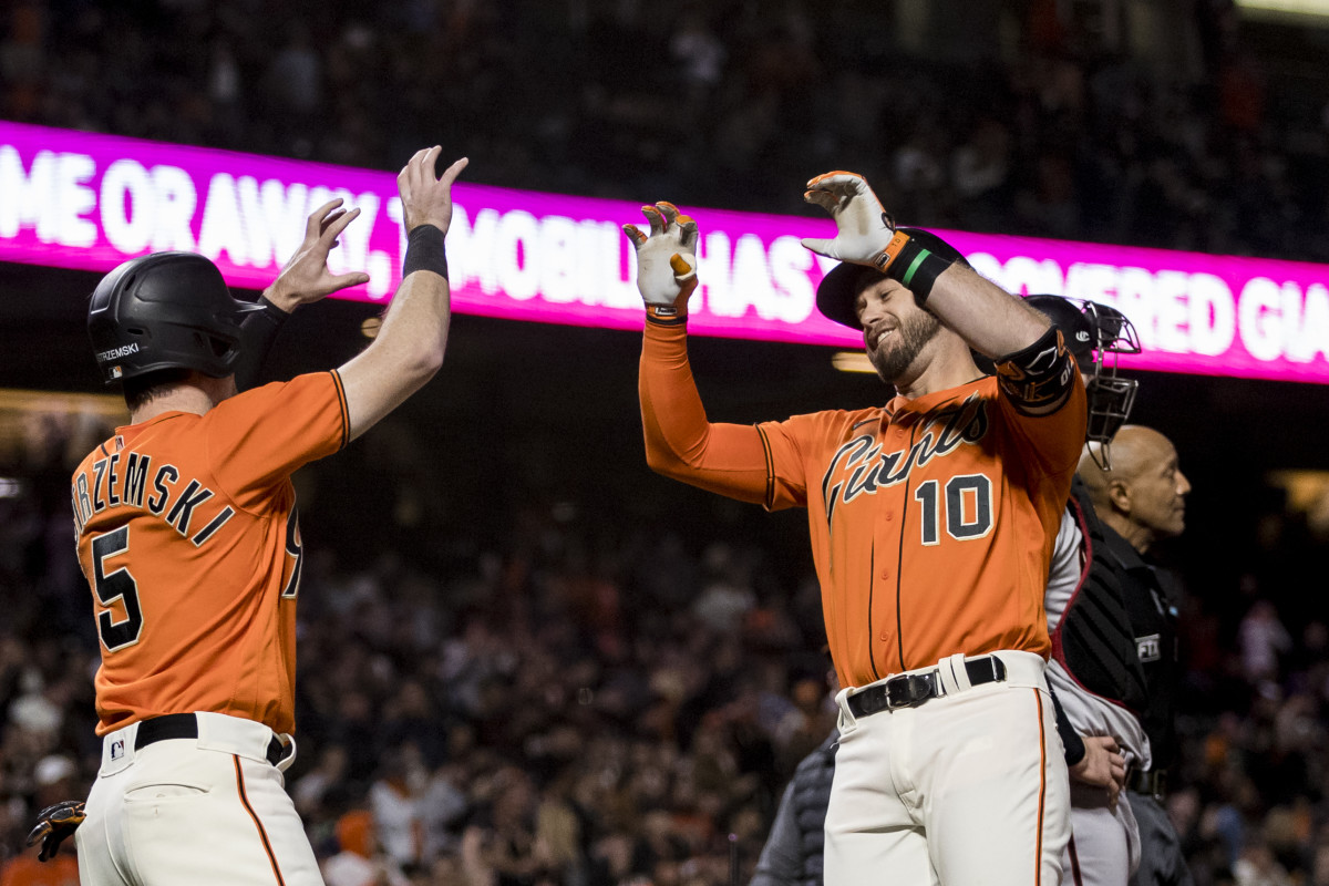 SF Giants third baseman Evan Longoria celebrates with Mike Yastrzemski after hitting a grand slam.